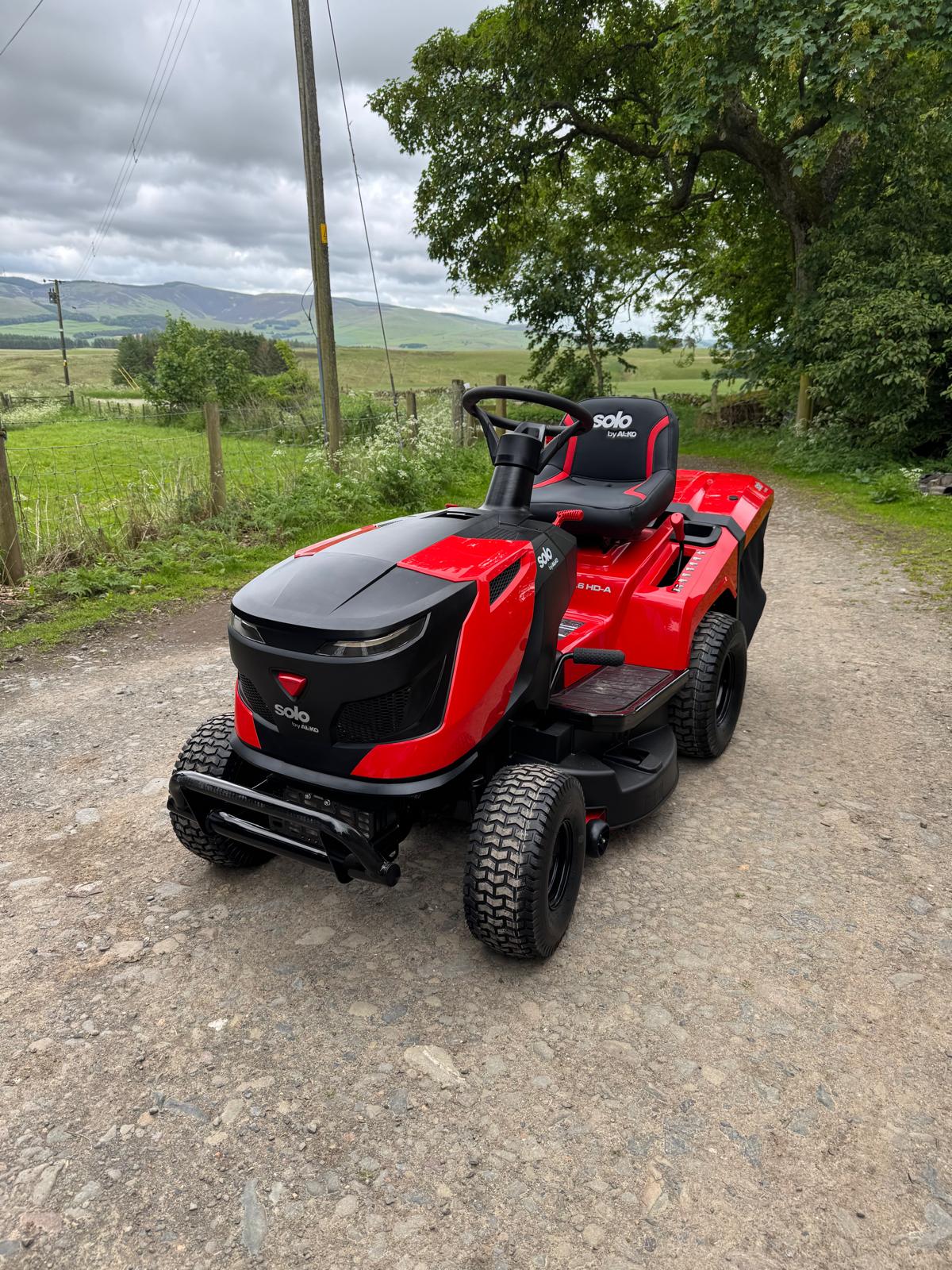 Red Solo by AL-KO ride-on mower on a farm track